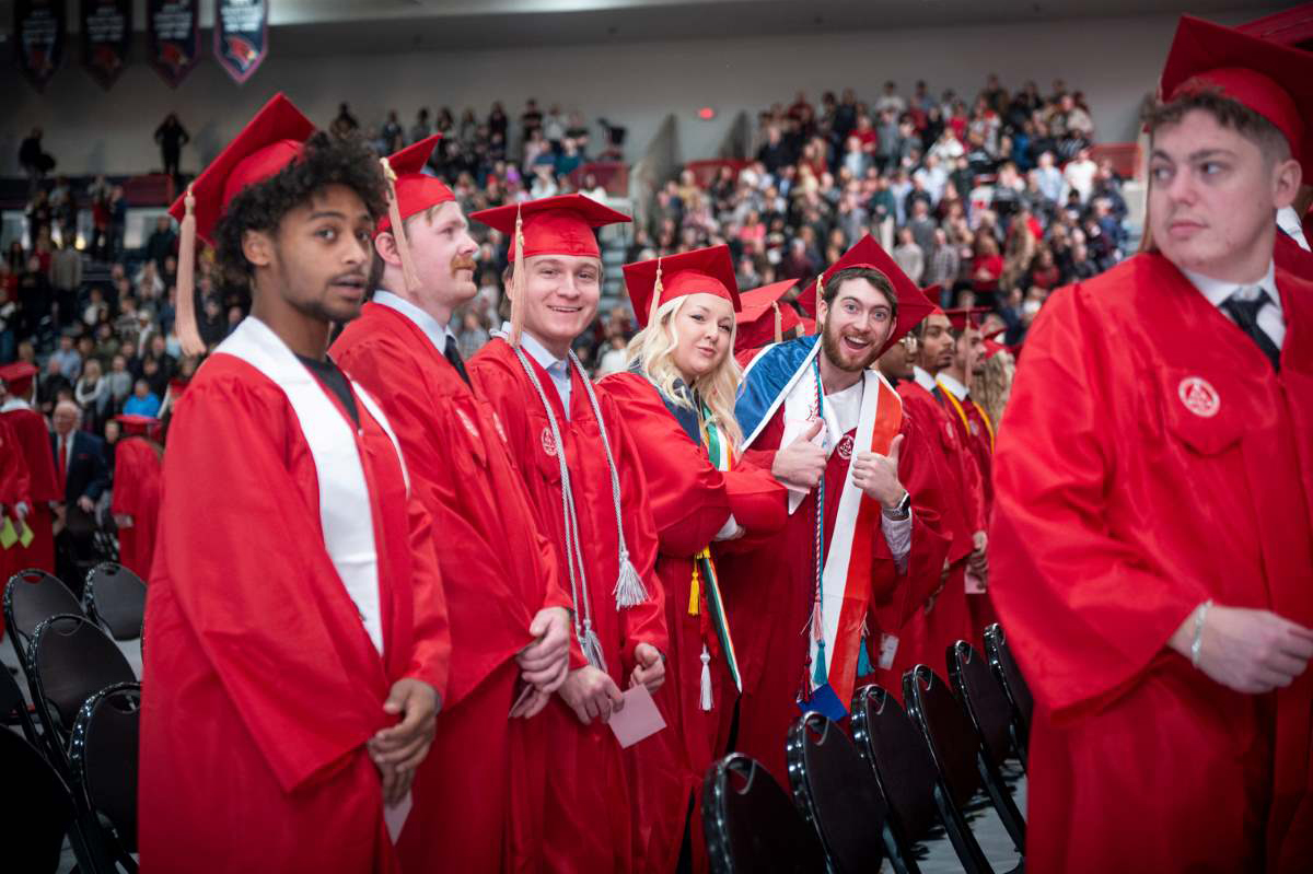 students in red graduation gowns